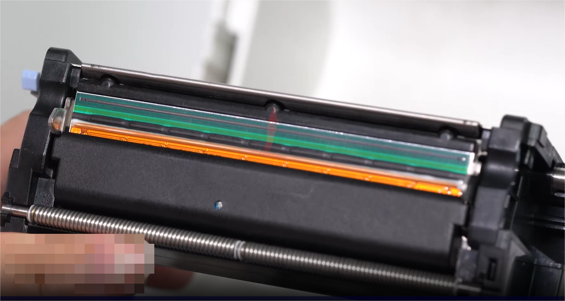 Az A close-up of a person carefully cleaning an electronic component with a swab.